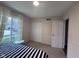 Bedroom with a bed, a window with curtains, a closet, and a door leading to another room at 5240 Regency Dr, Columbus, IN 47203