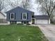 Charming home with a blue exterior, white trim, and a well-maintained lawn at 5240 Regency Dr, Columbus, IN 47203