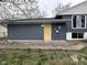 Exterior of home with blue siding, bright yellow door, and a well-maintained walkway leading to the entrance at 5240 Regency Dr, Columbus, IN 47203