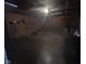 This is a photo of a dimly lit garage interior with walls covered in tools, and with concrete flooring at 5240 Regency Dr, Columbus, IN 47203