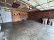 Bright, spacious garage featuring ample storage, a pegboard for tools, and easy access to lawn care equipment at 5240 Regency Dr, Columbus, IN 47203