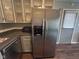 Kitchen includes updated stainless steel refrigerator and light-painted cabinets at 5240 Regency Dr, Columbus, IN 47203