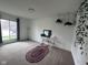 Living room featuring a carpet, a large window, hanging plants, and neutral walls at 5240 Regency Dr, Columbus, IN 47203