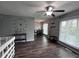 Open living room with hardwood floors, an adjacent dining area, and a ceiling fan at 5240 Regency Dr, Columbus, IN 47203