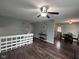 Open concept living space with hardwood floors, ceiling fan, and view of the dining area at 5240 Regency Dr, Columbus, IN 47203