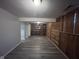 The rec room has wood-look flooring, wood accent walls, and built-in shelving for organized storage at 5240 Regency Dr, Columbus, IN 47203