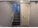 The home's staircase features access to the upper and lower levels, as well as access to a storage closet at 5240 Regency Dr, Columbus, IN 47203