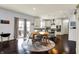Cozy dining area adjacent to the kitchen with wood floors, a circular rug, and a view of the outdoor patio at 5247 Crowley Pkwy, Whitestown, IN 46075