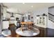 Open dining area with wood floors, views of the kitchen and staircase, and comfortable seating for Gathering meals at 5247 Crowley Pkwy, Whitestown, IN 46075