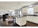 Open concept kitchen with white cabinets, granite countertops, and island adjacent to the living room at 5247 Crowley Pkwy, Whitestown, IN 46075