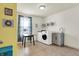 Well-lit laundry room with modern washer, dryer, utility sink and window at 5247 Crowley Pkwy, Whitestown, IN 46075