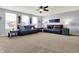 Spacious living room with two sofas, ceiling fan, and large windows providing natural light at 5247 Crowley Pkwy, Whitestown, IN 46075