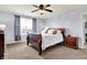 Comfortable main bedroom with a sleigh bed, ceiling fan, and carpeted floors, creating a relaxing atmosphere at 5247 Crowley Pkwy, Whitestown, IN 46075