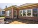 This covered patio area features brick and large windows bringing the outside in, ideal for entertaining guests at 528 Dylan Dr, Carmel, IN 46032