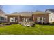 This backyard features a lush lawn, stone fountain, and established greenery creating a peaceful retreat at 528 Dylan Dr, Carmel, IN 46032