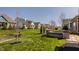 This home features a landscaped yard, including mature trees and flowering bushes with a stone retaining wall at 528 Dylan Dr, Carmel, IN 46032