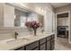 Elegant bathroom featuring a dual sink vanity with quartz countertop and modern faucets and open access to laundry at 528 Dylan Dr, Carmel, IN 46032