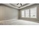 Primary bedroom with neutral carpet, ceiling fan, and large windows providing lots of natural light at 528 Dylan Dr, Carmel, IN 46032