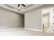 Spacious bedroom featuring tray ceilings, neutral paint, and a doorway to an en-suite bathroom at 528 Dylan Dr, Carmel, IN 46032