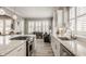 Modern kitchen with an island cooktop, stainless steel appliances, and a cozy breakfast nook with ample natural light at 528 Dylan Dr, Carmel, IN 46032