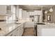 Well-lit kitchen with white cabinets, granite countertops, stainless steel appliances, and a central island with cooktop at 528 Dylan Dr, Carmel, IN 46032