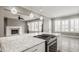 Open-concept kitchen with a large island, granite countertop, and stainless steel cooktop at 528 Dylan Dr, Carmel, IN 46032