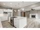 Spacious kitchen boasts a large island with a cooktop and stainless steel appliances, adjacent to living area at 528 Dylan Dr, Carmel, IN 46032