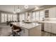 Bright kitchen with a large center island, modern appliances, stylish pendant lighting, and ample counter space at 528 Dylan Dr, Carmel, IN 46032