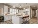 Spacious kitchen featuring white cabinetry, a large island with seating, and stainless steel appliances, perfect for cooking at 528 Dylan Dr, Carmel, IN 46032
