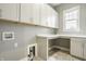 Laundry room featuring upper cabinets, counter space, utility sink, and tile flooring at 528 Dylan Dr, Carmel, IN 46032