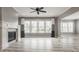 Living room with fireplace, ceiling fan, and large windows offering neighborhood views at 528 Dylan Dr, Carmel, IN 46032