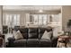 Comfortable living room showcasing a plush leather sofa with decorative pillows and an open view into the bright kitchen at 528 Dylan Dr, Carmel, IN 46032