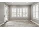 Bright living room with shuttered windows, neutral walls, and light-colored wood flooring at 528 Dylan Dr, Carmel, IN 46032