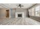Bright living room featuring a fireplace, ceiling fan, and large windows at 528 Dylan Dr, Carmel, IN 46032