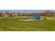Vibrant blue playground equipment with slides and climbing structures nestled in a lush green park at 528 Dylan Dr, Carmel, IN 46032