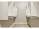 Bright walk-in closet with built in shelves and closet rods for optimal storage organization at 528 Dylan Dr, Carmel, IN 46032