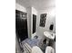 Stylish bathroom with blue tiled floor, black door and monochrome decor accents at 6225 Roberts Creek Ln, Indianapolis, IN 46221