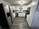 Bright kitchen with stainless steel appliances, white cabinetry, and sleek, dark countertops at 6225 Roberts Creek Ln, Indianapolis, IN 46221