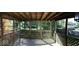 Enclosed porch featuring lattice details and views of the surrounding treed backyard at 6225 Roberts Creek Ln, Indianapolis, IN 46221