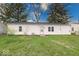 Well-maintained backyard with a lawn and the rear exterior of the house at 6501 Meadowlark Dr, Indianapolis, IN 46226