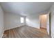 Bright bedroom featuring new laminate flooring, fresh paint, and natural light from the window at 6501 Meadowlark Dr, Indianapolis, IN 46226