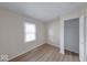 Cozy bedroom featuring wood-look floors, a window, and a closet at 6501 Meadowlark Dr, Indianapolis, IN 46226
