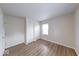 Bright bedroom featuring new laminate flooring, closet, and natural light from the window at 6501 Meadowlark Dr, Indianapolis, IN 46226