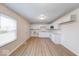 Open kitchen layout featuring white cabinets, new laminate flooring, and stainless-steel appliances at 6501 Meadowlark Dr, Indianapolis, IN 46226