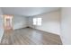 Bright living room featuring new laminate flooring, a front door, and a window allowing natural light at 6501 Meadowlark Dr, Indianapolis, IN 46226