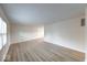 Bright living room featuring new laminate flooring, fresh paint, and a window letting in natural light at 6501 Meadowlark Dr, Indianapolis, IN 46226