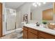Bathroom with white vanity, a shower with glass door, decorative artwork, and neutral-toned walls at 6742 S New Jersey St, Indianapolis, IN 46227