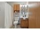 Bathroom featuring a shower curtain, oak cabinets, and a sink with a mirror at 6742 S New Jersey St, Indianapolis, IN 46227