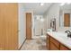 A full bathroom showcasing the shower with a glass enclosure, wood cabinets, and tiled flooring at 6742 S New Jersey St, Indianapolis, IN 46227