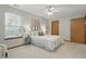 Bedroom featuring a ceiling fan, natural light, and neutral carpet, creating a tranquil and inviting space at 6742 S New Jersey St, Indianapolis, IN 46227